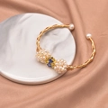 Golden woven pearl bracelet with blue enamel bow accent on marble background - Cloisonne Pearl Ball Style (GB0193)