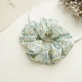 Detailed texture of floral scrunchie in light beige fabric with blue and yellow prints - Chiffon Floral Blue