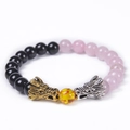 Detail of beaded dragon bracelet with black obsidian, rose quartz, and metallic dragon heads - Rose Quartz & Obsidian