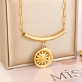 Close-up of golden sun and moon pendant on paperclip chain over a jewelry box - Sun Moon Pendant Style (KN236514-NT)
