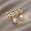 Macro view of gold pearl earrings with a sparkling zircon ring on champagne silk - 27# Micro-painted Do Pearl Earrings