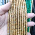 Macro detail of natural stone spacer beads for DIY jewelry making in various earthy tones - Yellow Wood Grain Stone