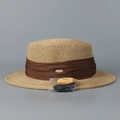 Close-up of woven boater hat with coffee pleated ribbon and UPF 50+ sun protection tag - M(56-58cm) / Coffee