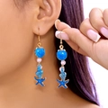 Blue ocean-style long dangle earrings with starfish shells and pearls on model - Deep Blue Starfish Set