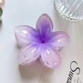 Close-up of translucent purple gradient frangipani flower hair claw clip with glossy finish - Purple
