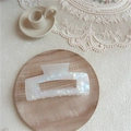 Close-up of a pearlescent rectangle acetate hair claw clip on a vintage wooden tray - Large Square / AB White