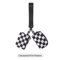 Close-up of checkered print wristlet bag with black nylon webbing and metal hardware - Black and White Plaid