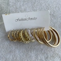 Golden earrings set with twisted hoops and faux pearls on a fashion jewelry display card - KC Gold (9511)