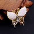 Elegant butterfly brooch in gold with white shell wings and shimmering crystals - White Butterfly