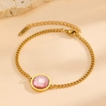 Detailed close-up of 18K gold plated chain bracelet with a faceted round pink gemstone - Gold Round Pink Zirconia (E412)