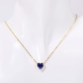 Gold stainless steel heart pendant necklace with dark blue birthstone on a mannequin - September