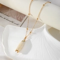 Bohemian gold beaded chain necklace featuring a white shell cone pendant with gold plated edges - Milky White Tapered Pendant