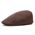 Close-up of the breathable brown mesh fabric and structured profile of the flat cap - Coffee