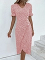 Detailed view of pink floral dress featuring puff sleeves and white button accents - Pink