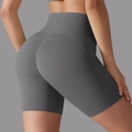 Rear view of high-waisted grey yoga shorts featuring peach-lift seams and elastic fabric - Titanium Gray