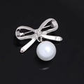 Elegant silver bow brooch with a hanging white round pearl on a dark background - Plain Bowknot Silver Pearl