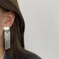 Chic silver heart tassel earrings in durable titanium steel, side view on model - Silver