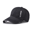 Detail of distressed ripped edges on a washed black denim baseball cap with vintage finish - Adjustable / Black