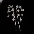 Detailed view of silver star tassel earrings with rhinestones on black velvet background - Silver Pin - Silver Star Tassel Earrings