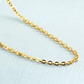 Gold-tone interlinked oval chain link necklace on a light grey textured background - O-shape Chain