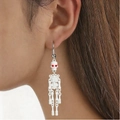 Gothic skull earrings in white with red eyes worn by a model for Halloween style - White Red Eyes Skull Earrings (WG-0863)