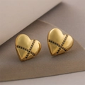 Detailed macro view of 18K gold plated heart earrings with black zircon cross patterns - Heart Cross Studs