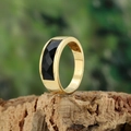 Close-up of golden stainless steel ring with rectangular black gemstone on wood base - Size 7 / Gold Color Blue Sandstone