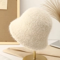 Chic cream white plush bucket hat for women on a stylish gold metal display stand - Off-white