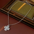 Detailed shot of a silver clover pendant necklace with clear sparkling zirconia stones - Necklace - Silver