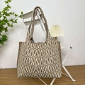 Detail of knitted tote bag with brown and beige wave geometric texture on chair - Wave Khaki