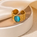 Macro shot of vintage gold-plated ring with oval turquoise opal and hollow texture - Braided Blue Cat's Eye Adjustable Style (TYR0819)