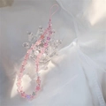 Dettaglio del cinturino per cellulare con perle a stella rosa in una ciotola a corona - Stella Rosa
