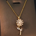 Close-up of golden necklace featuring a floral pendant with clear zircon gemstones - Gold - Rotating Floral