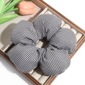 Detailed view of a black and white gingham oversized floral scrunchie on a display tray - Small Black & White Checkered (Approx. 14.5cm)