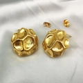 Detail view of 18K gold plated titanium steel earrings with a hammered texture on white silk - Gold - Hammered Geometric Polyhedron