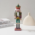 Detailed view of a Christmas wooden nutcracker soldier on a minimalist white display - Sword Style / 30cm
