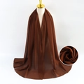 Solid brown pearl chiffon scarf for women draped elegantly on a display mannequin - Dark Red
