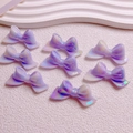 Detailed view of iridescent purple resin bow beads with dual-tone finish for DIY jewelry - 20x46mm/Aperture Approx 2.5mm / Luminous Iridescent Purple