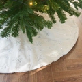 White plush Christmas tree skirt with silver snowflake sequins on wooden floor - Silver Snowflake / 145cm