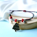 Christmas themed bracelet featuring green tree charm and red green woven rope - Star Christmas Tree