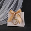 Elegant white wedding favor bag with golden Thank You text and a satin silk bow - White Box + Champagne Gold Ribbon