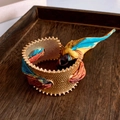 Macro shot of matte gold wide cuff with textured surface and colorful silk weave detail - Gold Yellow Printed Silk Scarf Bangle (Wide)