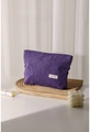 Detail of purple corduroy makeup bag with H&R label on a wooden tray with soft lighting - Purple