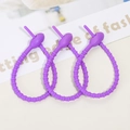 Detailed view of three purple silicone cable ties with non-slip perforated locking head - Purple