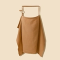 Close-up of muslin cotton nursing cover featuring a boned neckline and adjustable neck strap - Camel with Wooden Ring