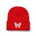 Red knit beanie featuring white butterfly embroidery and classic ribbed cuff design - One Size / Red