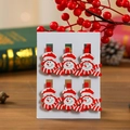 Detail of six wooden snowman clips on white card with festive background decoration - Snowman