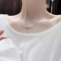 Minimalist silver bean pendant on a sleek snake chain necklace worn by model - Silver Minimalist Pendant