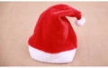 Close-up of a plush red and white Christmas hat with soft fur texture and white pompom - Short Plush Adult Style