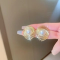 Vintage style gold swirl stud earrings with center pearl accent worn on fingers - 34# Silver Pin-Gold (Wrap)